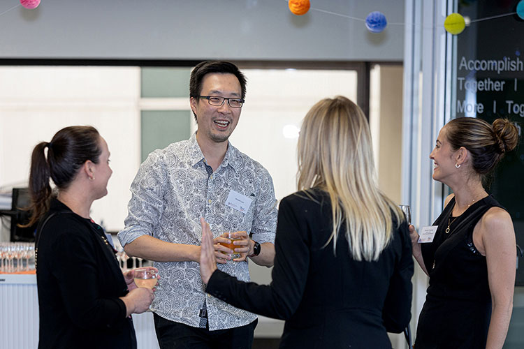 Vincent Lam laughing with group of guests