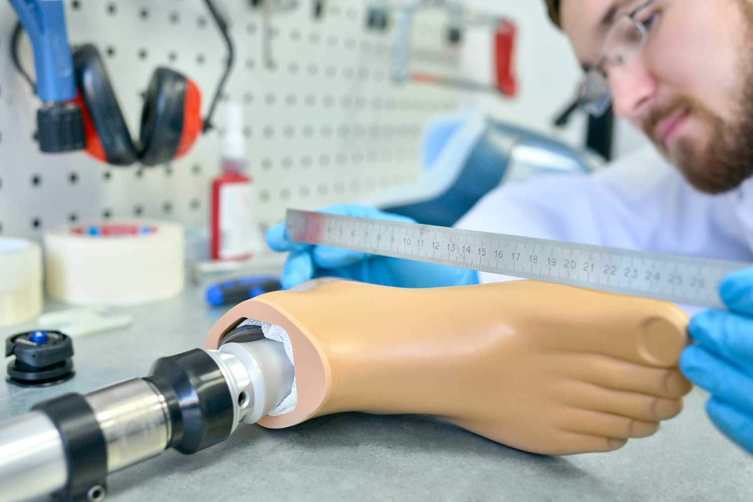 man wearing glasses making a prosthetic foot